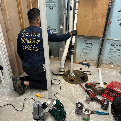Plumber works on a sump pump.